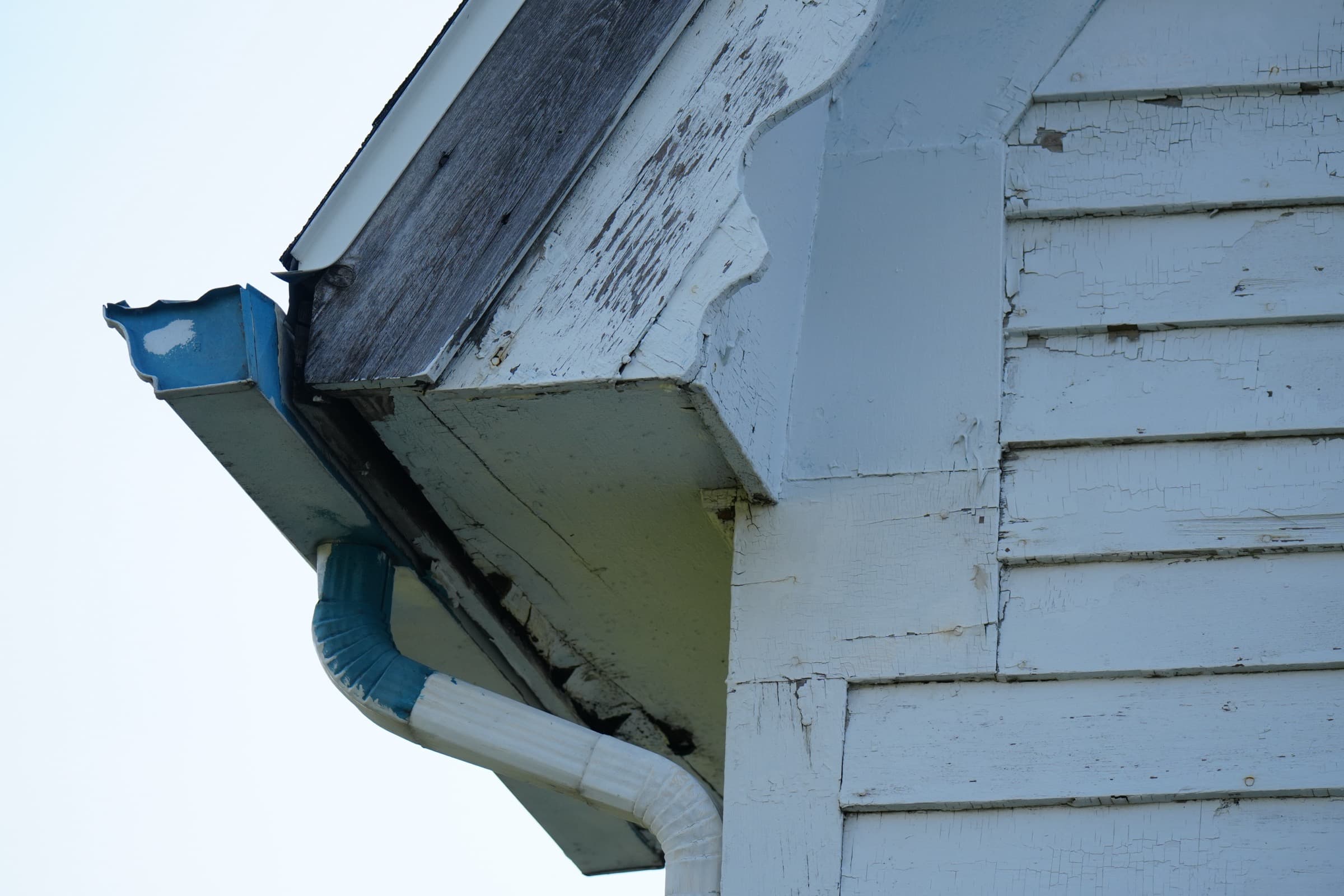 Damaged gutters and peeling fascia — deferred exterior maintenance that often signals bigger issues